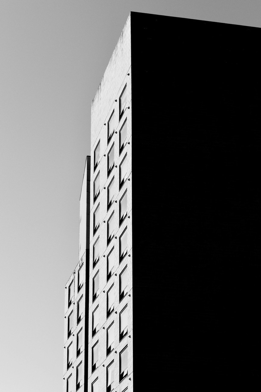 A building corner with identical windows repeating in uniform rows